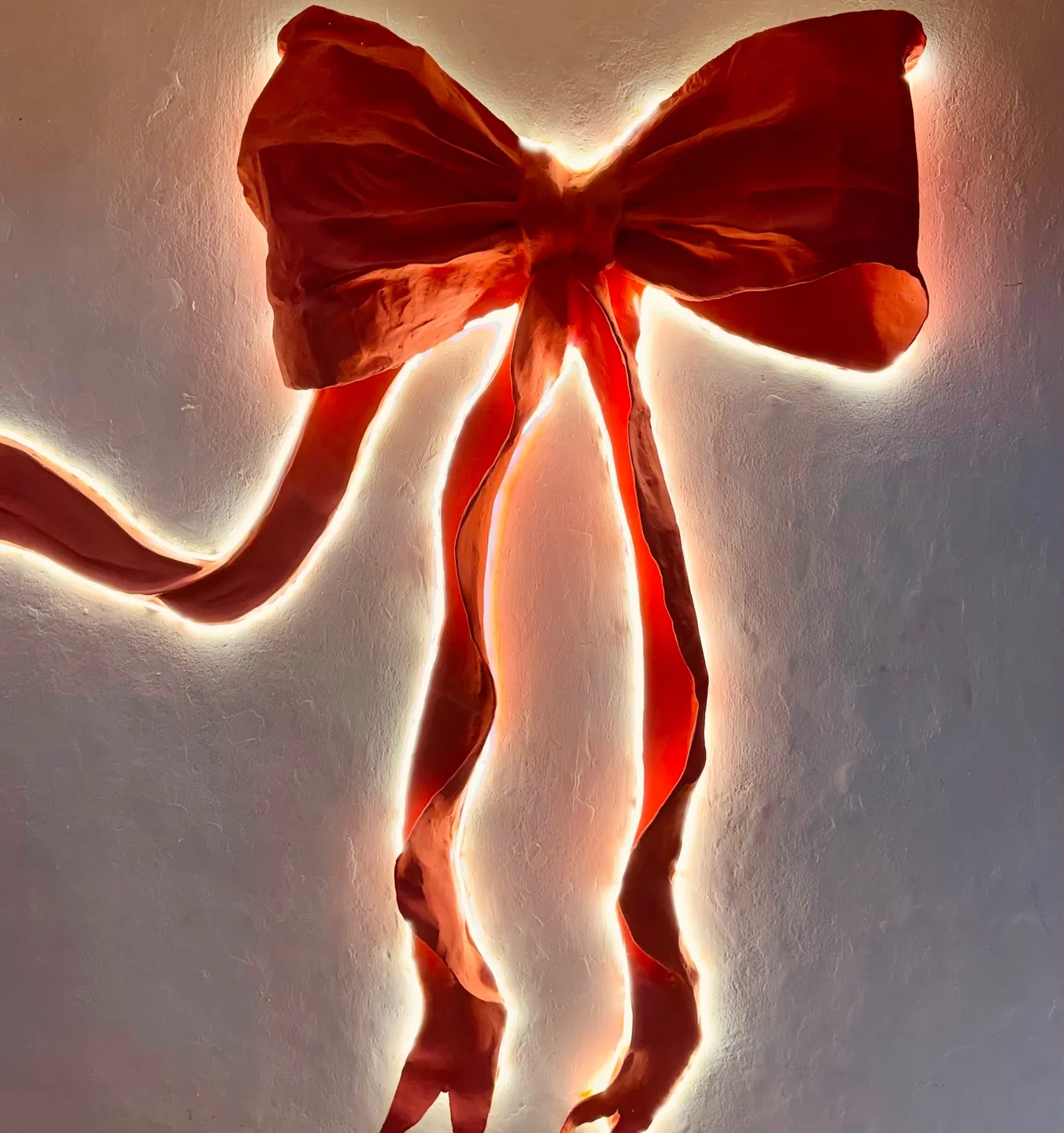 The big glowing pink bow on the Cookiora café wall