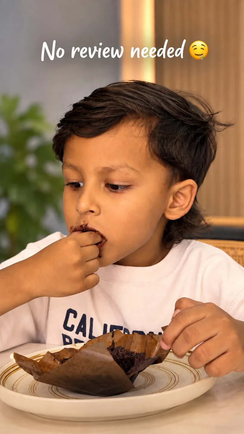 A boy eating a brownie: no review needed